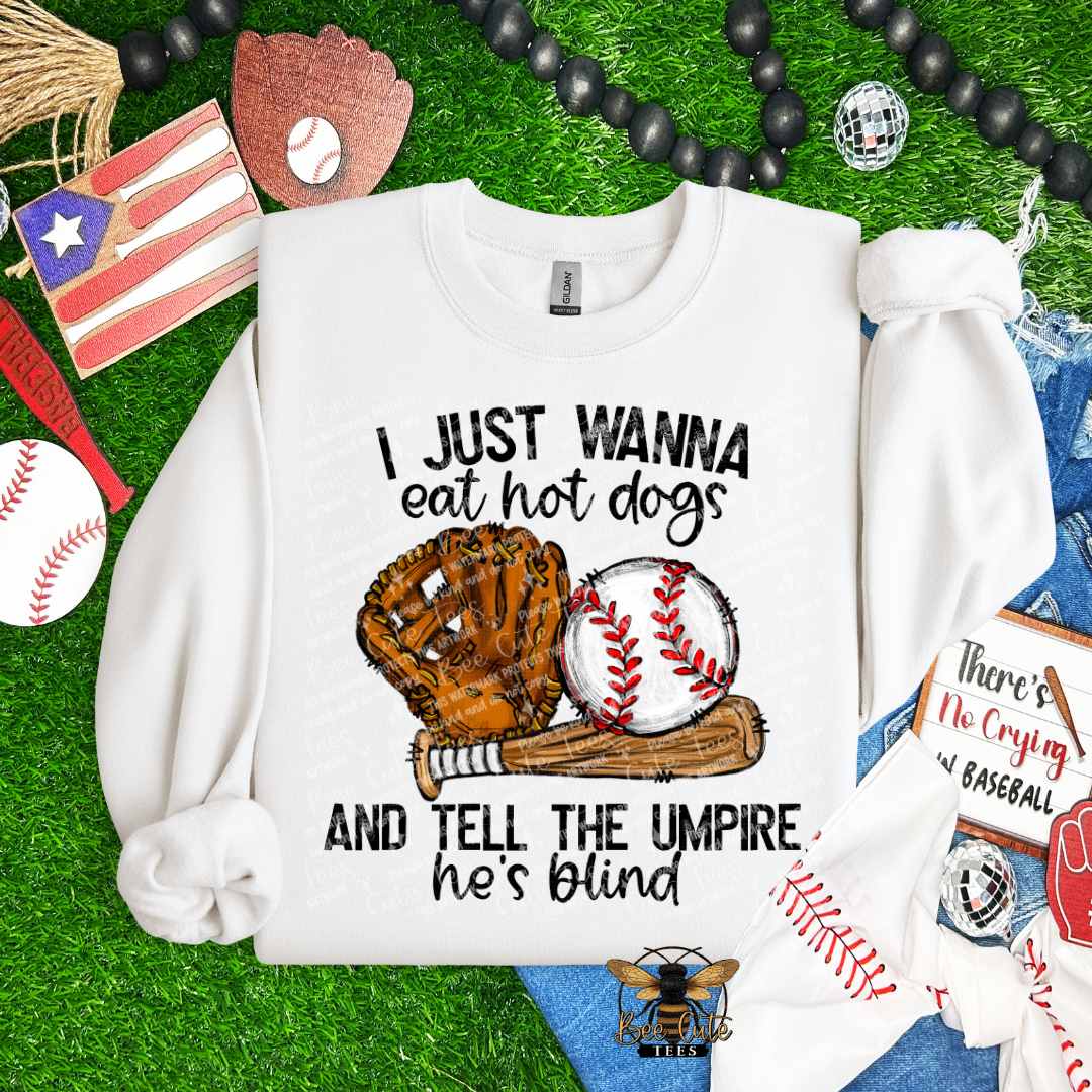 White sweatshirt with baseball-themed text and graphics on a grass background with sports-related items.