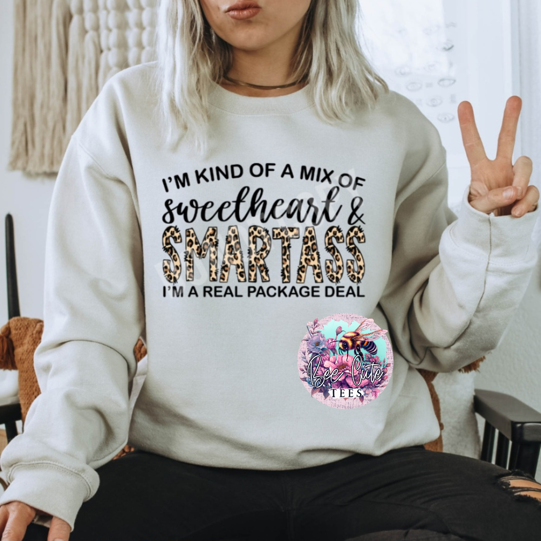 Person wearing a sweatshirt with text and a peace sign gesture