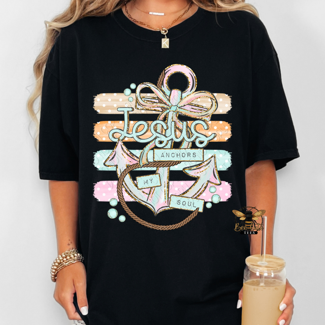 Black t-shirt with colorful anchor design and text held by a person.