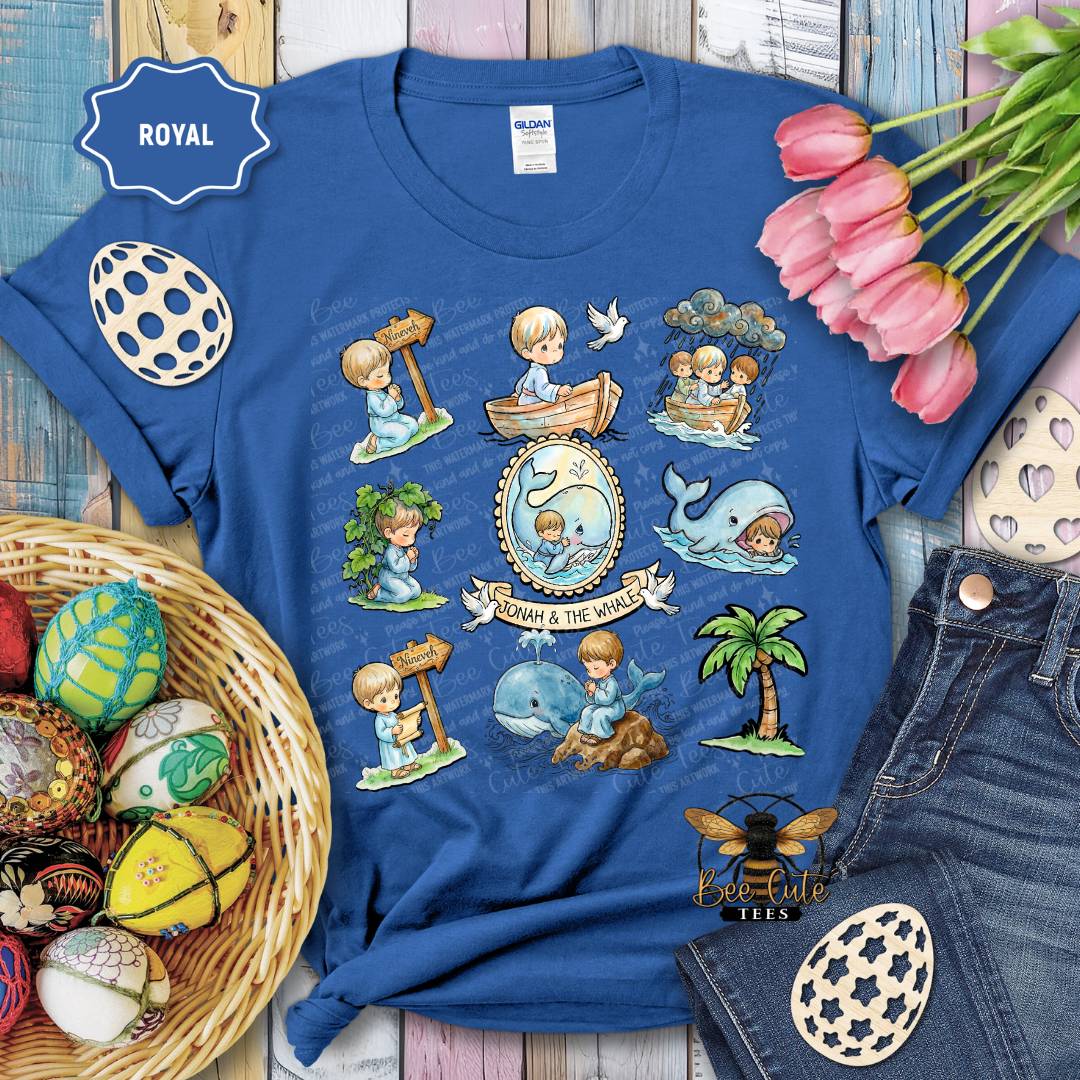 Blue t-shirt with 'Noah and the Whale' design, surrounded by decorative items on a wooden surface.