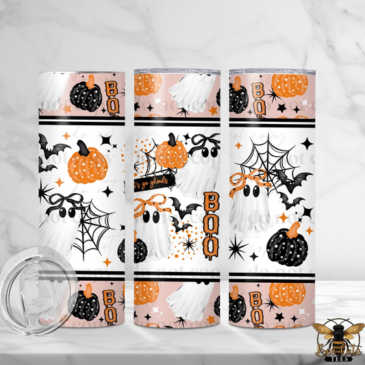 Three tall insulated tumblers with a Halloween-themed wrap design featuring ghosts, pumpkins, bats, spiderwebs, and the word 'BOO' in orange. A clear lid is shown separately in the lower left on a light marble surface.