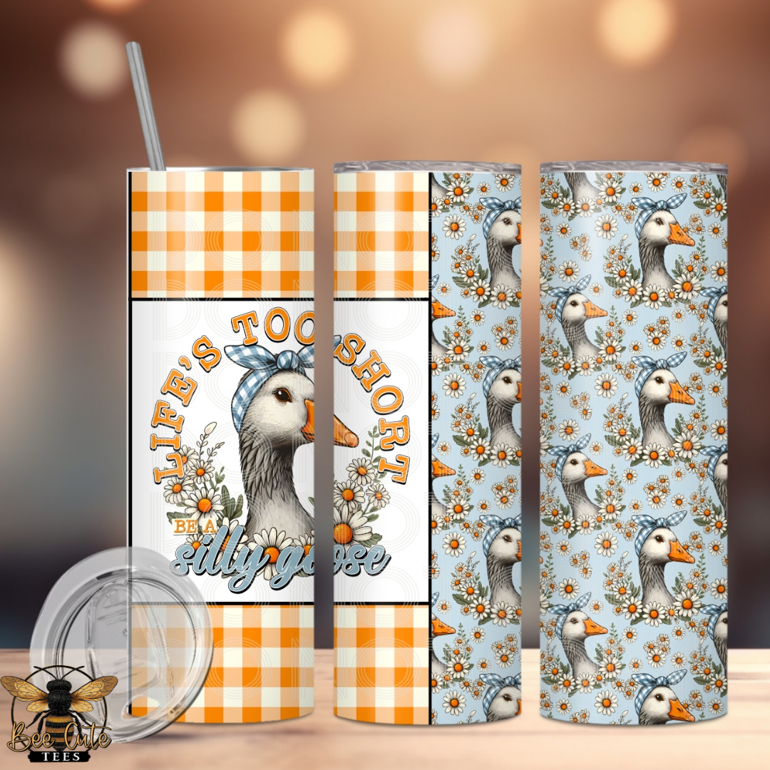 Two tumblers with duck designs and text on a blurred background