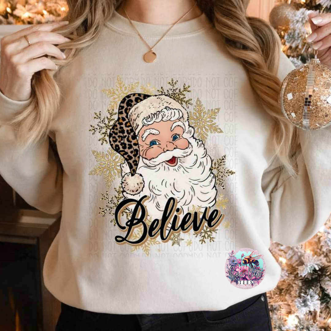 woman wearing a beige crewneck sweatshirt with a Santa graphic design in a Christmas setting