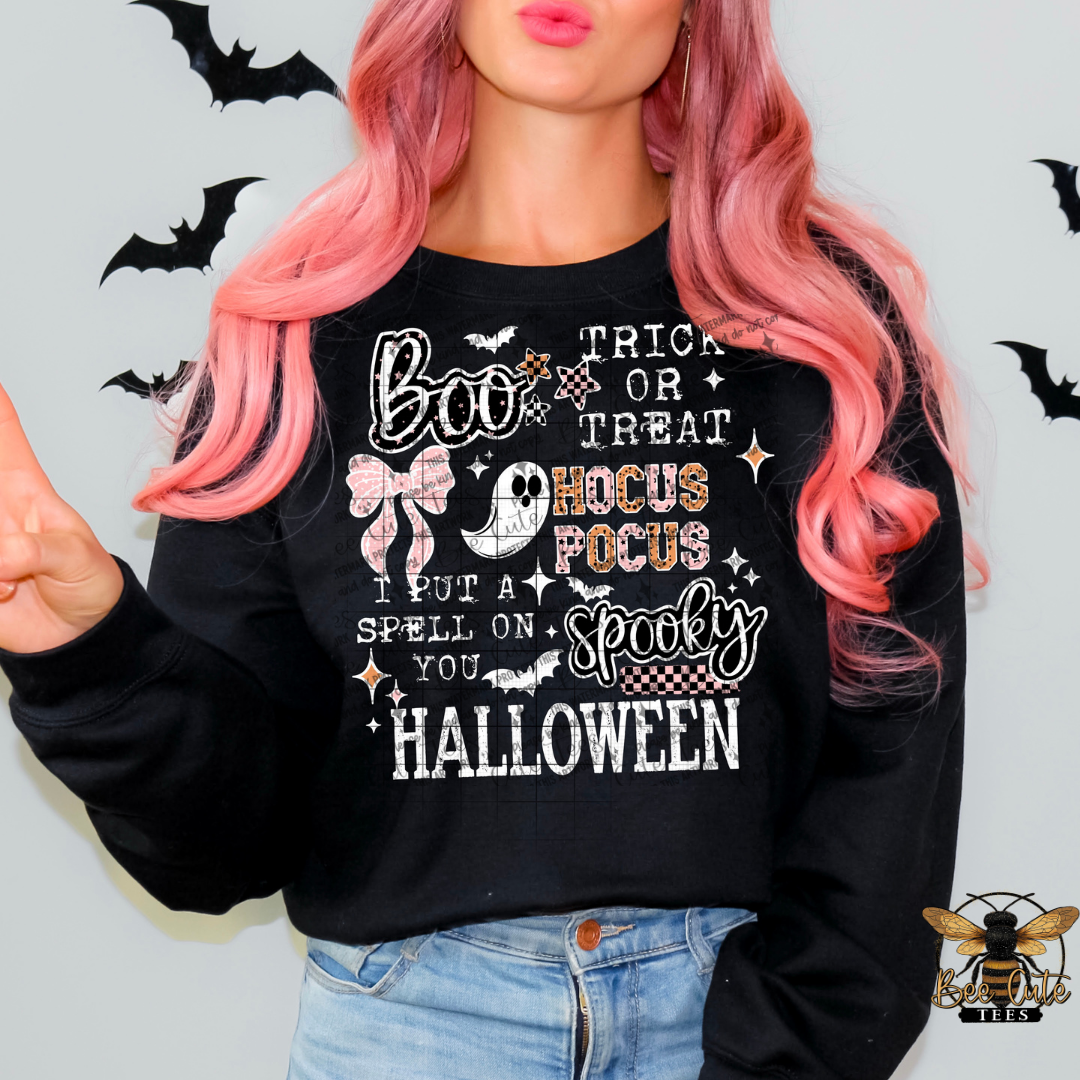 Person wearing a black Halloween-themed sweatshirt with text and graphics.