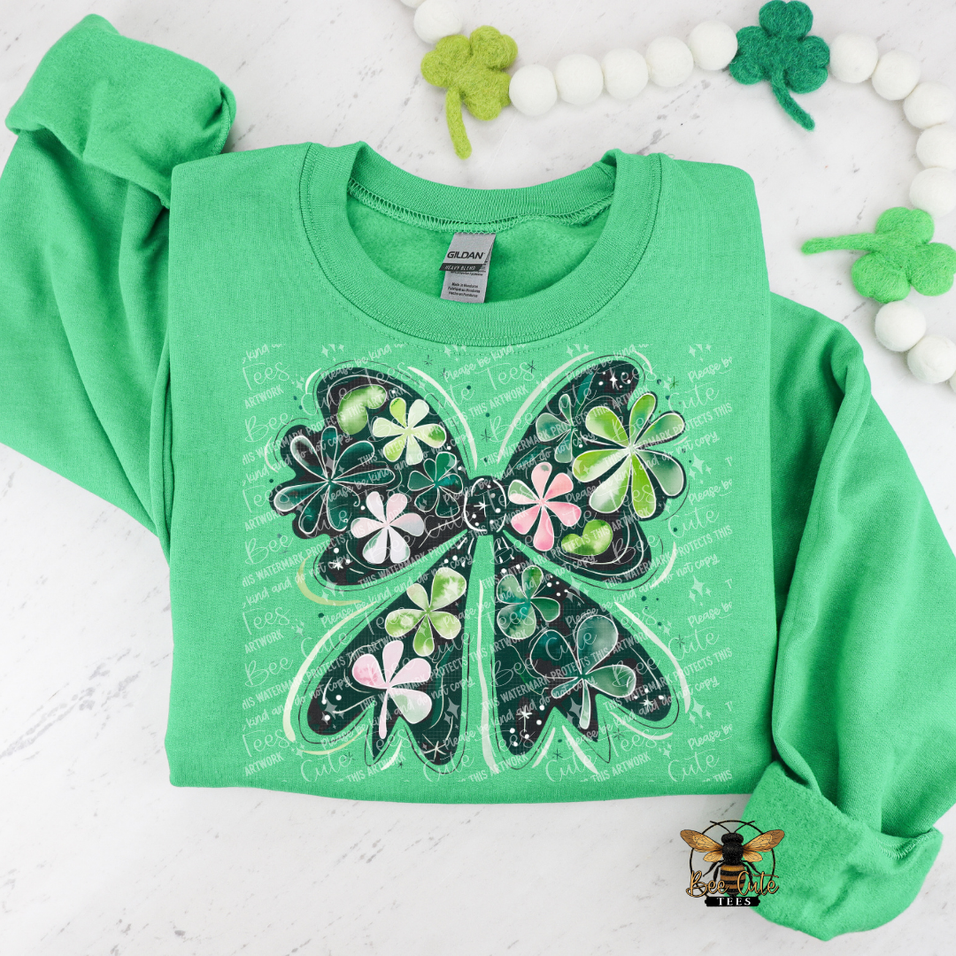 Green long-sleeve shirt with a shamrock bow design on a white background