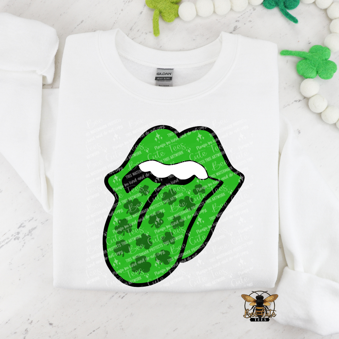White sweatshirt with green lips graphic and shamrock pattern on a white background