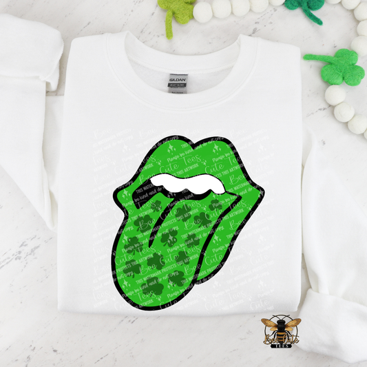 White sweatshirt with green lips graphic and shamrock pattern on a white background
