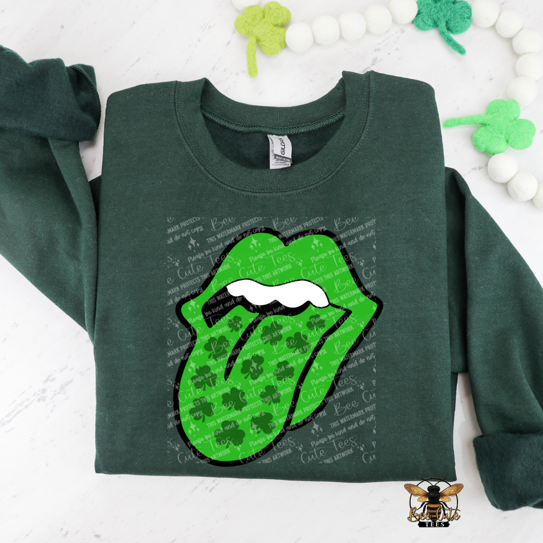 Green sweatshirt with logo featuring shamrocks on a white background with decorative elements.