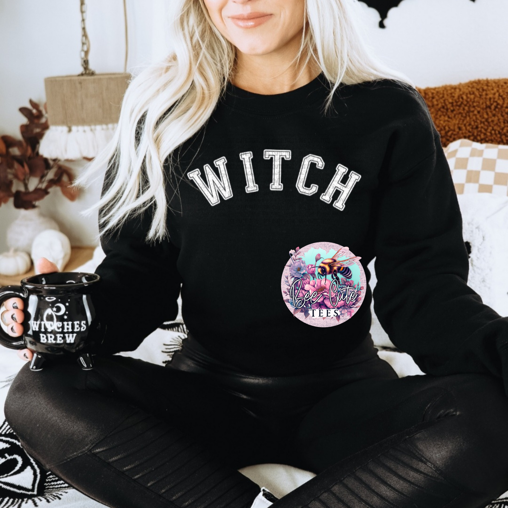 Black Halloween sweatshirt featuring large white varsity-style “WITCH” lettering across the chest for a simple, spooky seasonal look.
