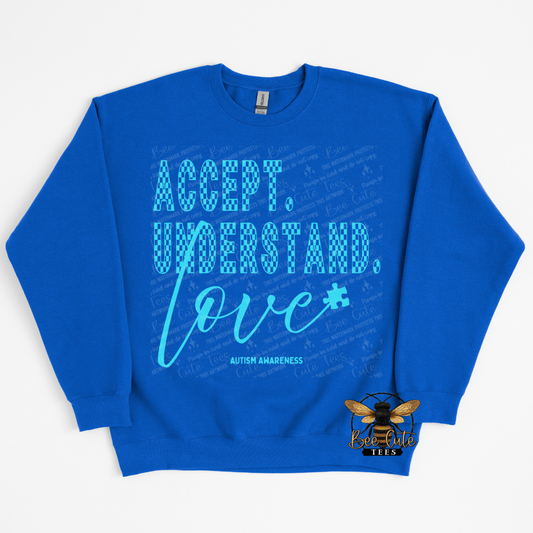 Blue sweatshirt with 'Accept. Understand. Love.' text on a white background