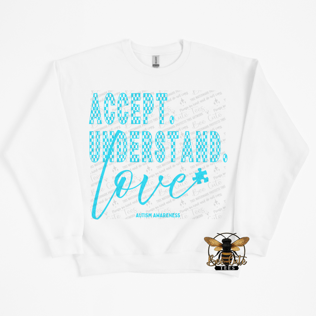 White sweatshirt with blue text 'ACCEPT. UNDERSTAND. LOVE.' and a bee logo on a white background