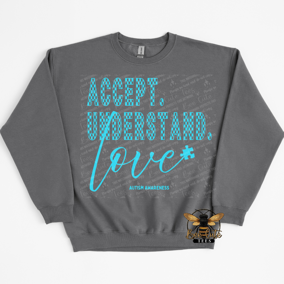 Gray sweatshirt with 'Accept. Understand. Love.' text and autism awareness symbol on a white background
