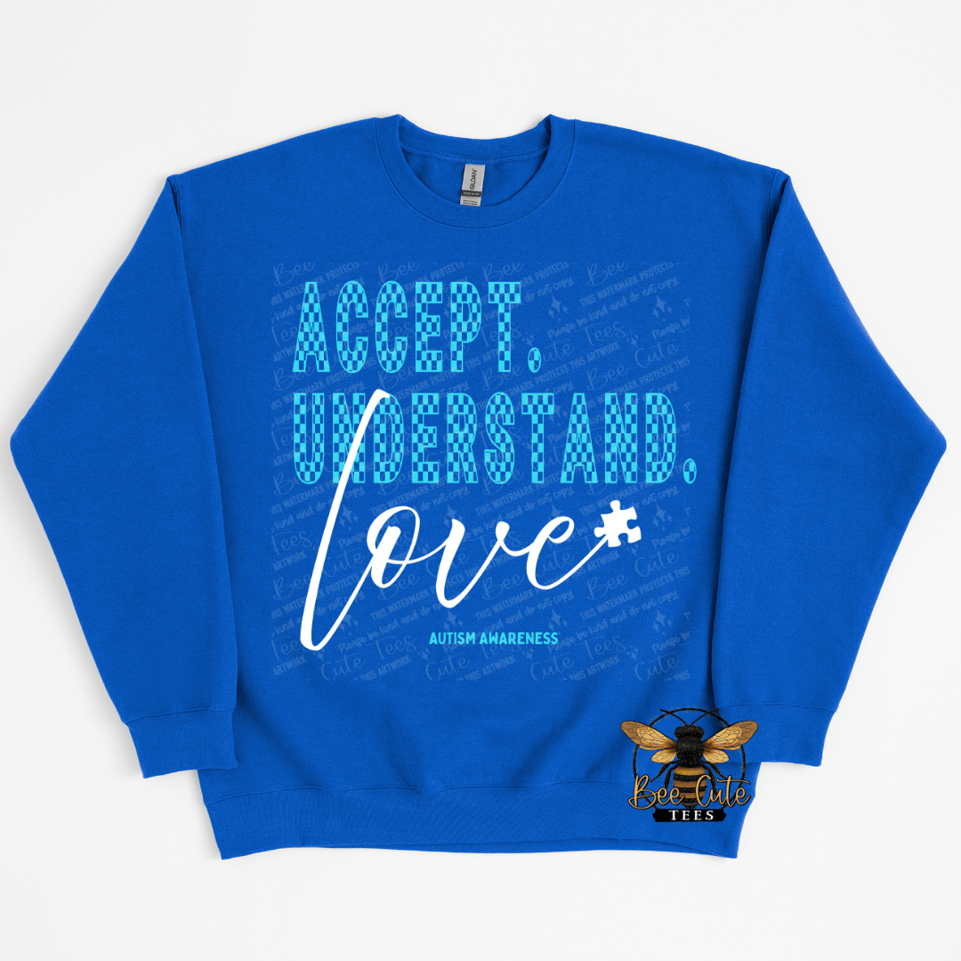 Blue sweatshirt with 'Accept. Understand. Love.' text on a white background