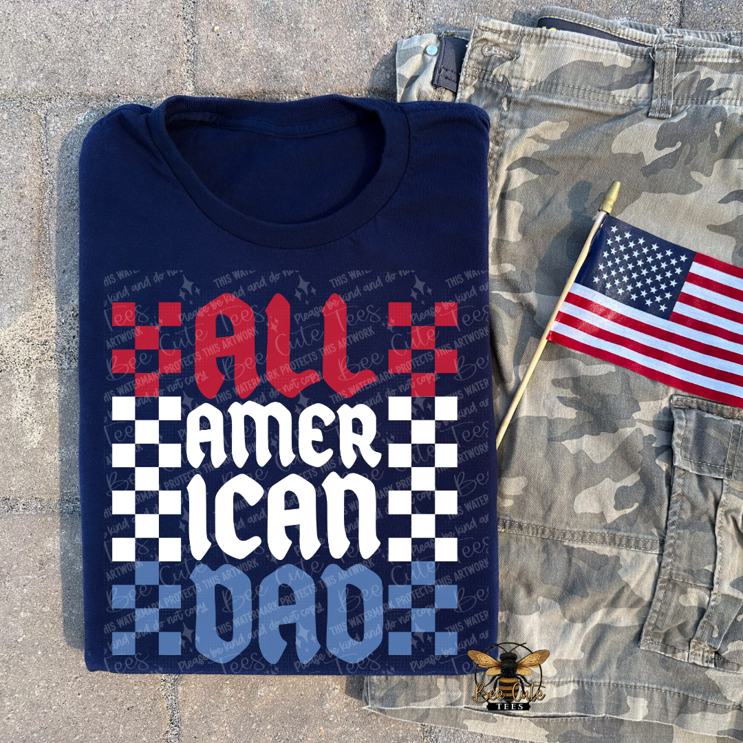 Folded navy blue t-shirt with 'All American Dad' text and an American flag on a camouflage background.