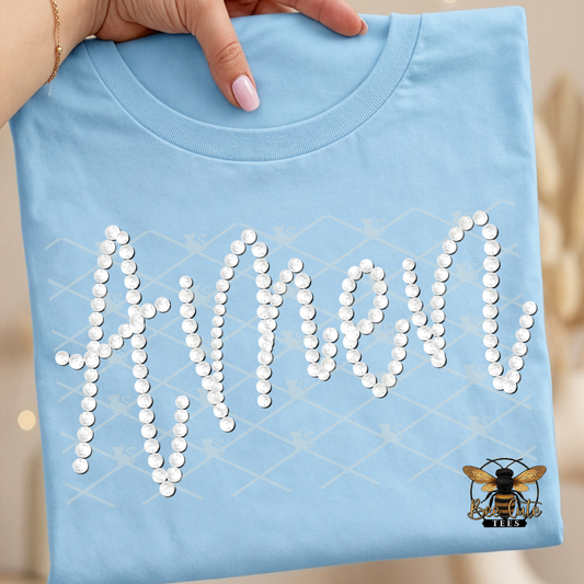 Light blue t-shirt with 'Amen' in faux  white pearls held by a hand.