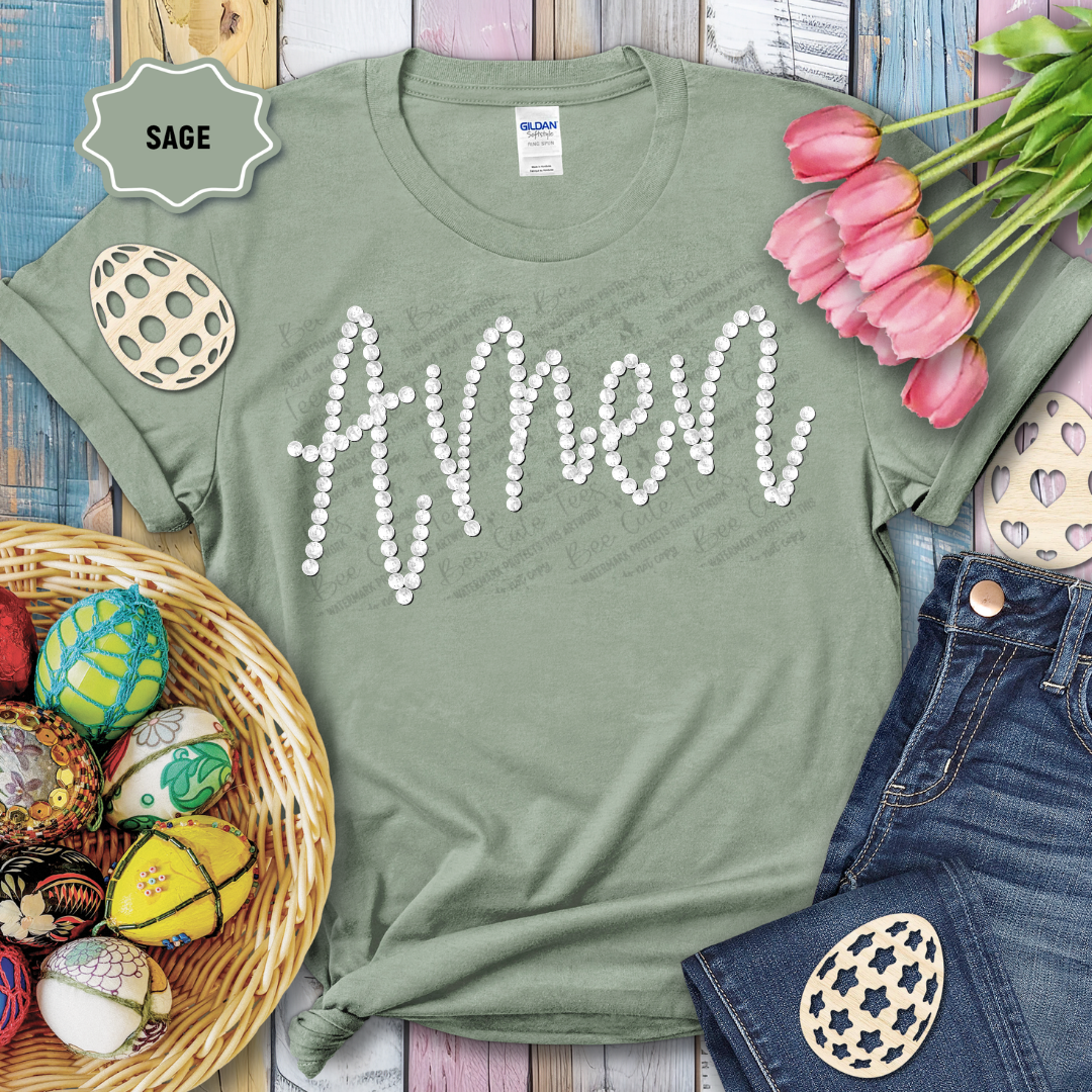 Green t-shirt with 'Amen' text, surrounded by Easter decorations on a wooden surface.