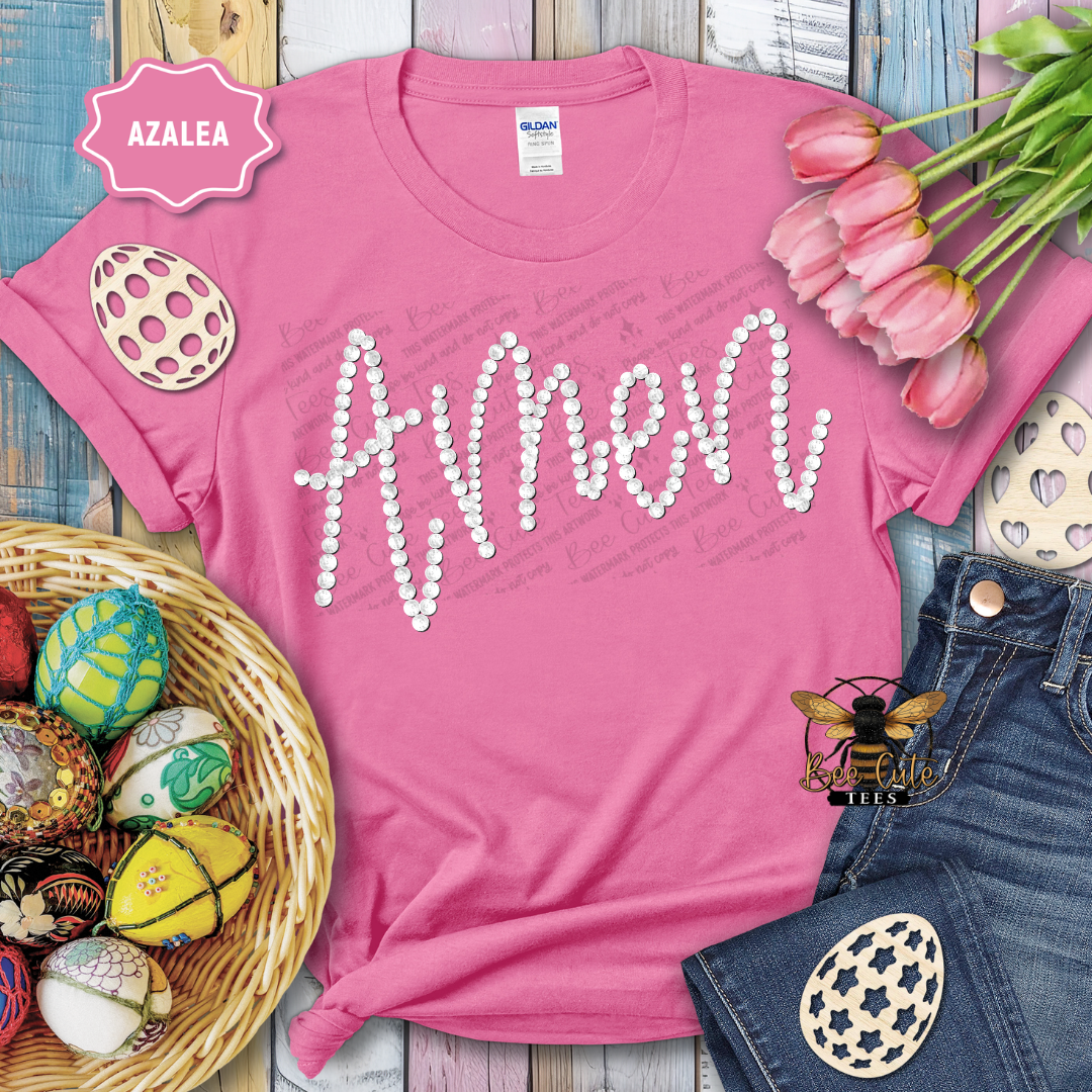 Pink t-shirt with 'Amen' text, Easter eggs, and tulips on a wooden surface