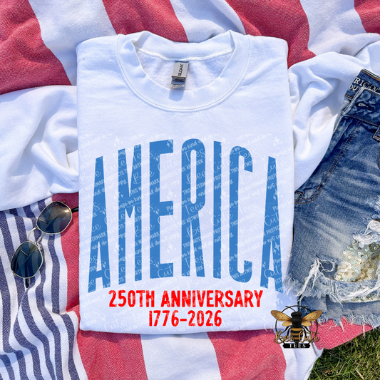 White t-shirt with 'AMERICA 250TH ANNIVERSARY 1776-2026' text on a flag background