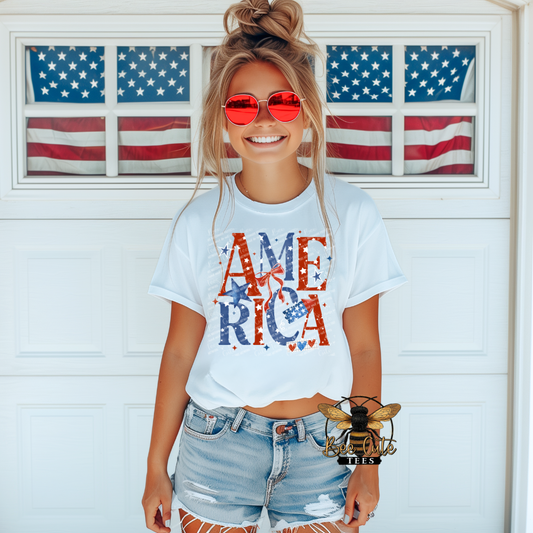 Woman wearing a 'AMERICA' t-shirt with American flags in the background