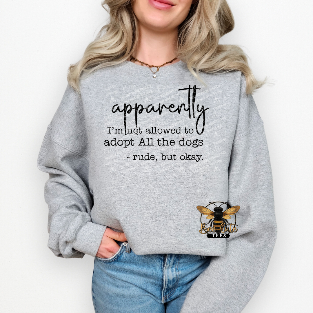 Person wearing a gray sweatshirt with text and a logo on a white background