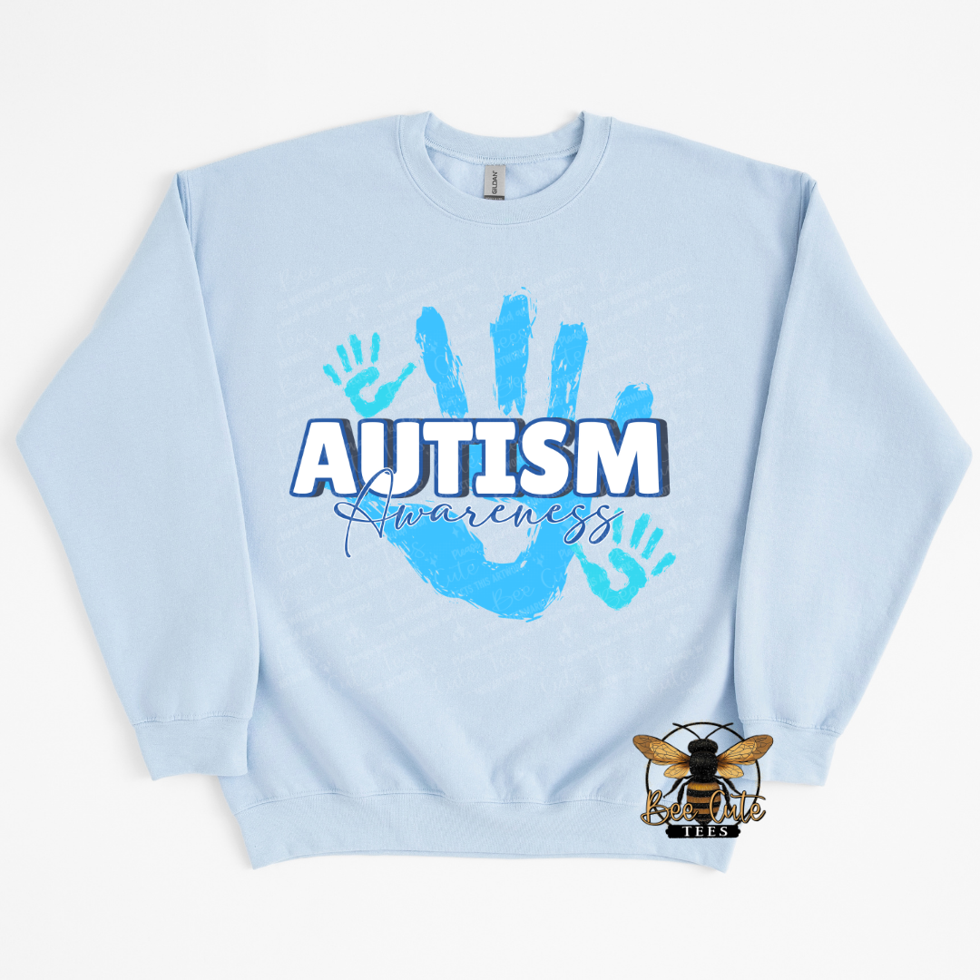 Light blue sweatshirt with 'Autism Awareness' text and handprints on a white background