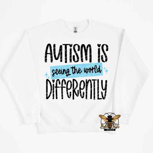 White sweatshirt with 'Autism is seeing the world differently' text and a bee logo on a white background