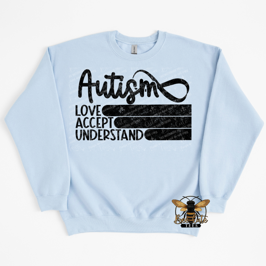 Light blue sweatshirt with black text 'Autism Love Accept Understand' on a white background