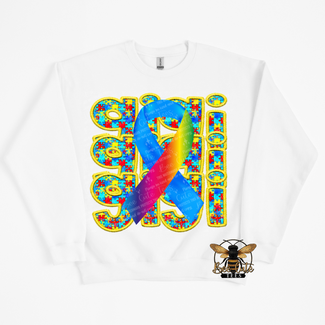 White t-shirt with a colorful ribbon and puzzle piece design on a white background
