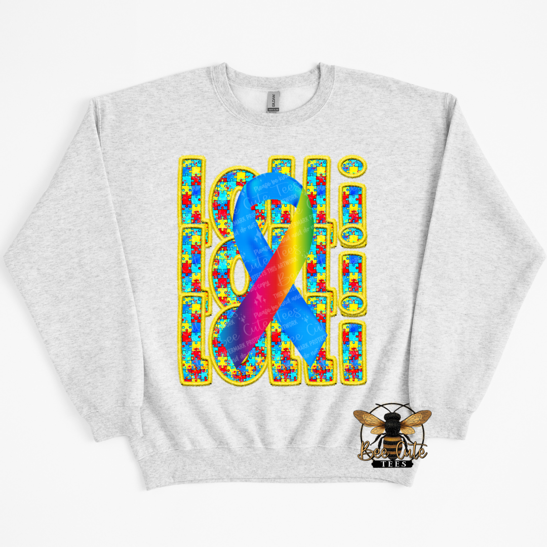 Gray sweatshirt with colorful autism awareness design on a white background