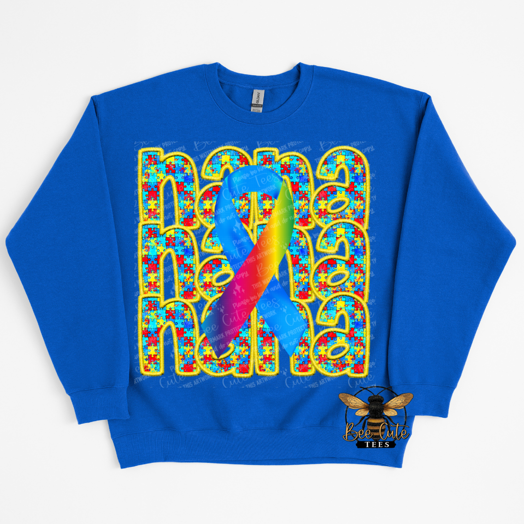 Blue sweatshirt with colorful design featuring a rainbow ribbon and puzzle pieces on a white background.
