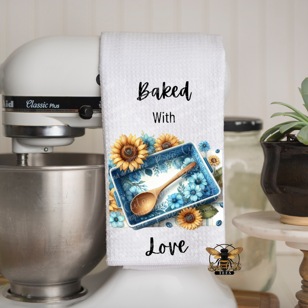 Kitchen towel with floral design and text 'Baked With Love' hanging on a mixer.