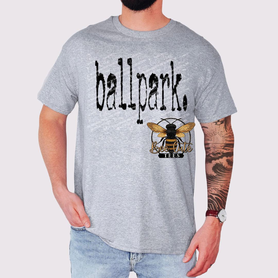 Person wearing a gray t-shirt with 'ballpark' and bee logo design.