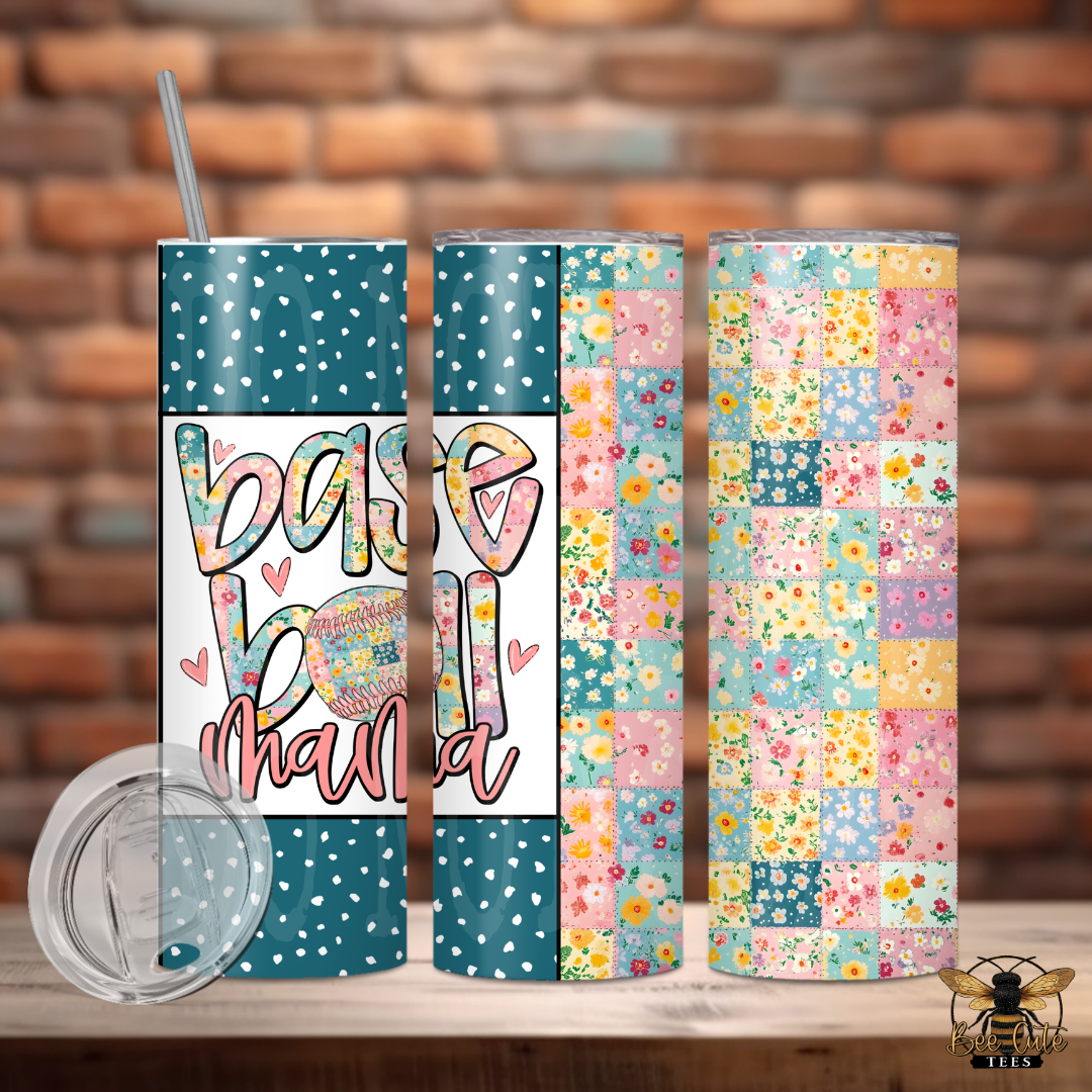 Three colorful tumblers with floral patterns and text on a wooden surface against a brick wall background.
