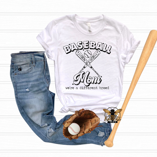White t-shirt with 'Baseball Mom' design, jeans, baseball glove, and bat on a white background