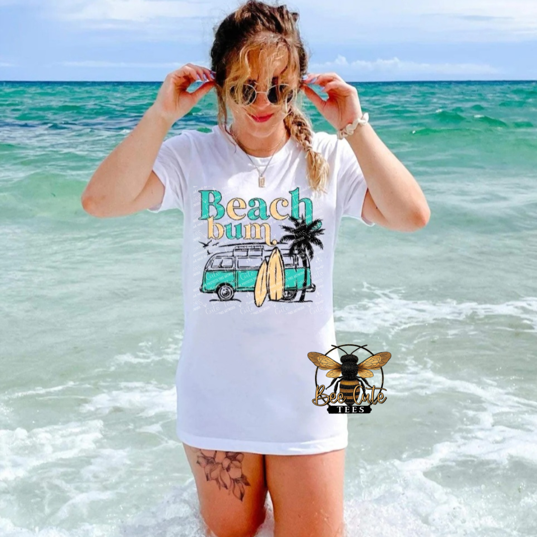 Woman wearing a 'Beach Bum' t-shirt by the ocean