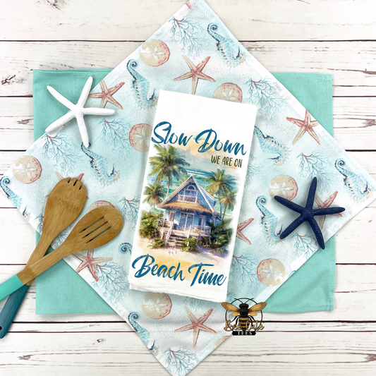 Beach-themed placemat with 'Slow Down, We're on Beach Time' card and starfish decorations.