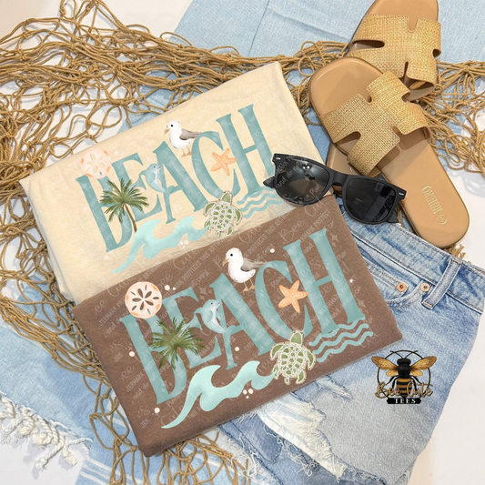 Two t-shirts with 'Beach' text, sunglasses, and sandals on a textured surface.
