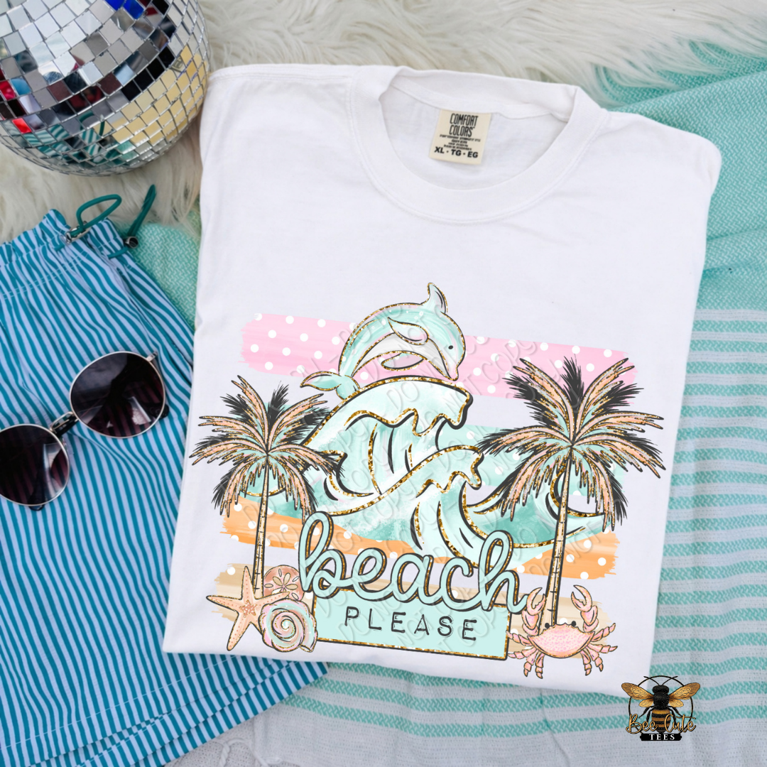 Folded t-shirt with 'Beach Please' design on a striped fabric background