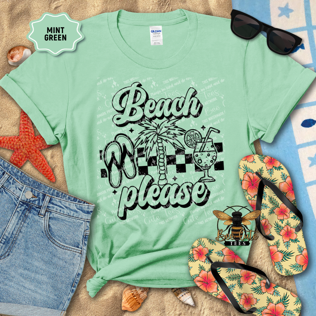 Mint green t-shirt with 'Beach Please' design on a sandy background with flip-flops and sunglasses.