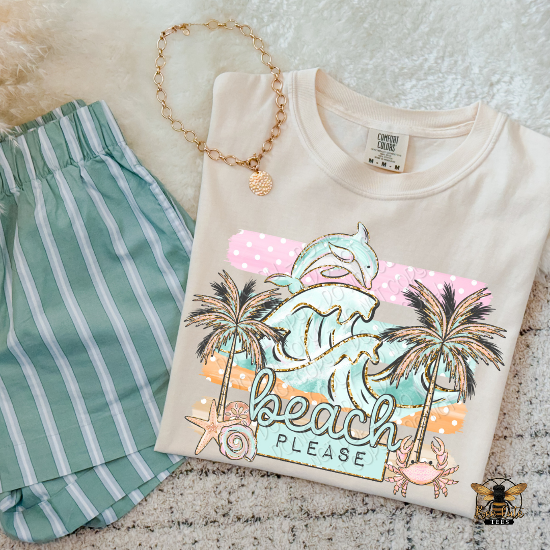 Beach-themed t-shirt with palm trees and text, paired with green shorts on a textured surface.