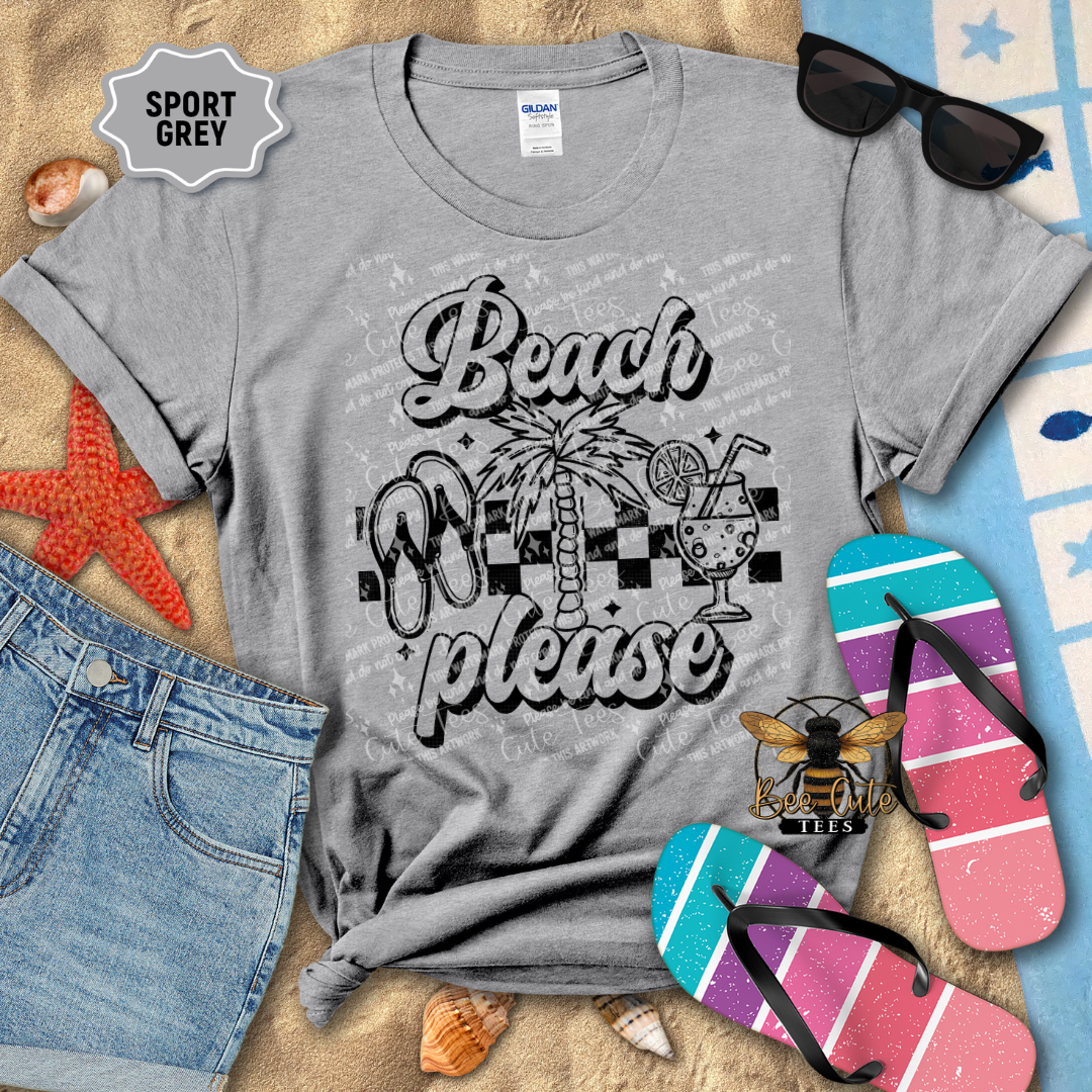 Gray t-shirt with 'Beach Please' design on a surface with beach-themed accessories.