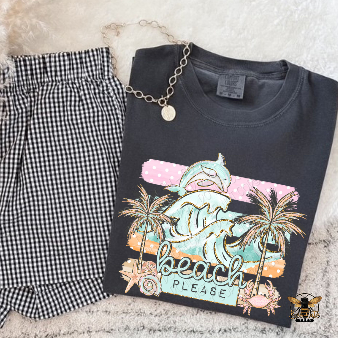 Black t-shirt with beach graphic design and checkered shorts on a textured surface
