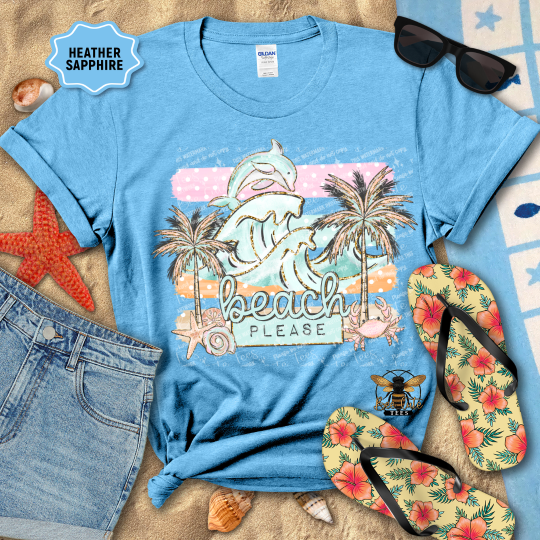 Blue t-shirt with beach-themed design, sunglasses, flip-flops, and denim shorts on a sandy background.