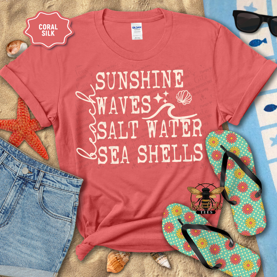 Orange t-shirt with beach-themed text on a sandy background with flip-flops and sunglasses.