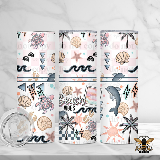 Three tumblers with beach-themed designs on a white background