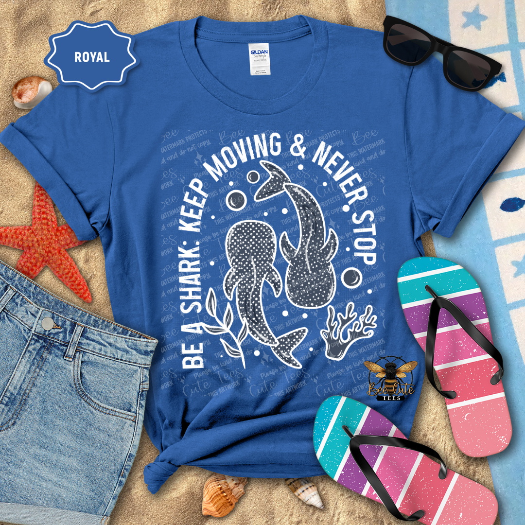 Blue t-shirt with shark design and text, sunglasses, jeans, and flip-flops on a beach-themed background.