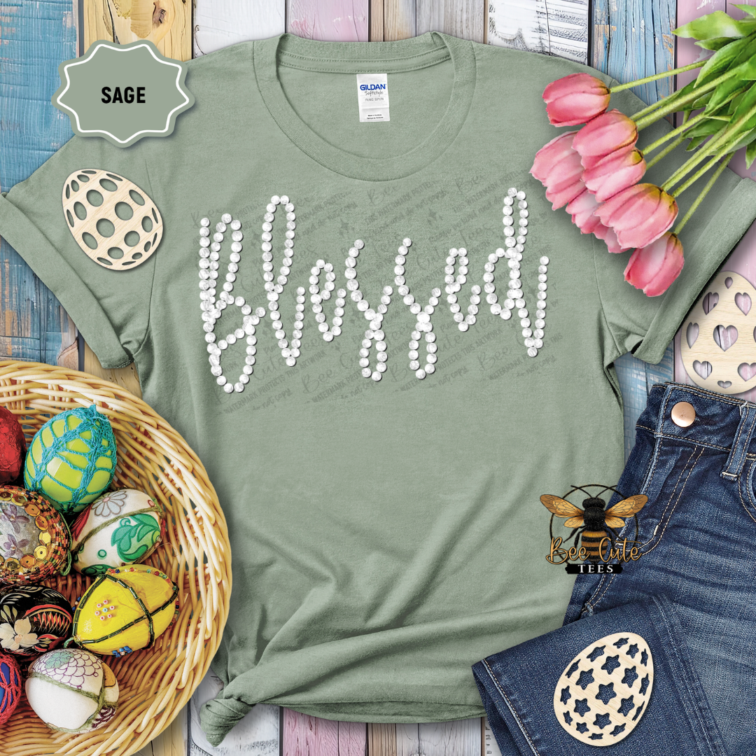 Green t-shirt with 'Blessed' text, surrounded by Easter decorations on a wooden surface.