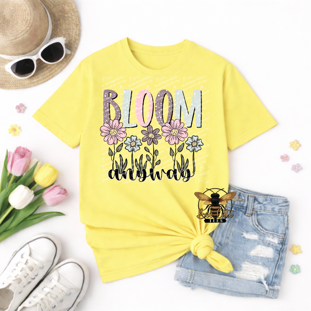 Yellow t-shirt with 'Bloom Anyway' design, sunglasses, tulips, and shorts on a white background