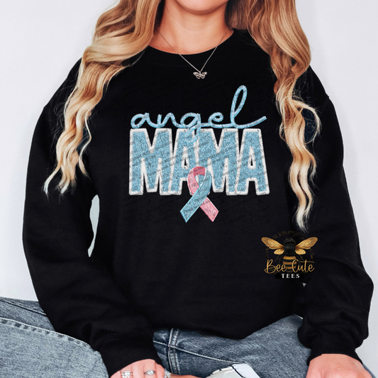 Black sweatshirt with 'angel mama' text and pink ribbon design, worn by a person.