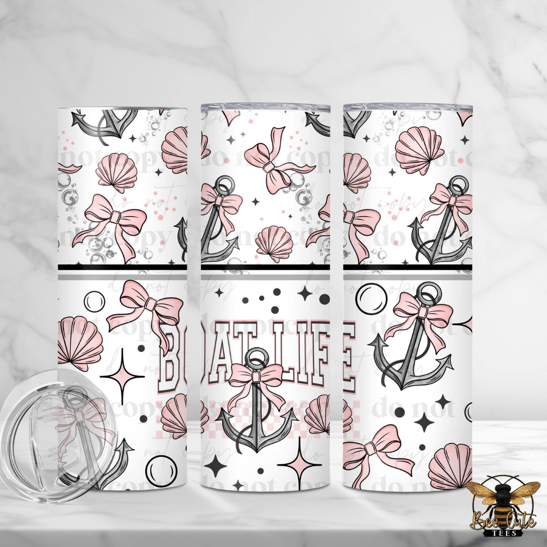 Set of three tumblers with pink and gray anchor designs on a white background